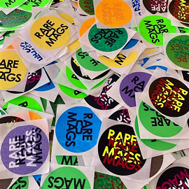 Pile of stickers that say Rare Mags on them