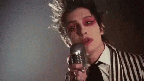 palaye royale gif of guy in stripy blazer singing