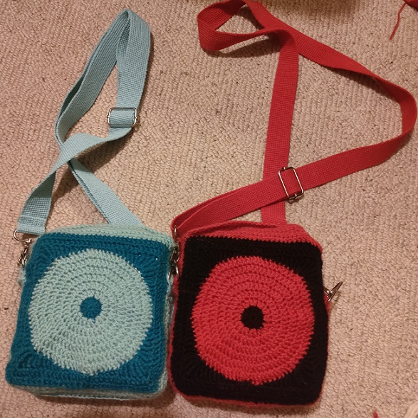 back of the satchels showing the contrast colour CD-shape.