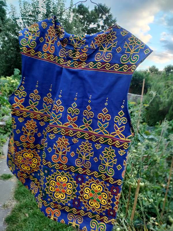 tank top in a royal blue African fabric with colourful geometric floral dot patterns.