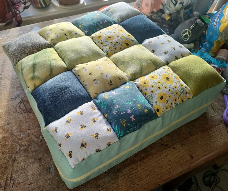 Patchwork cushion in yellow, green and blue with bee and floral motifs