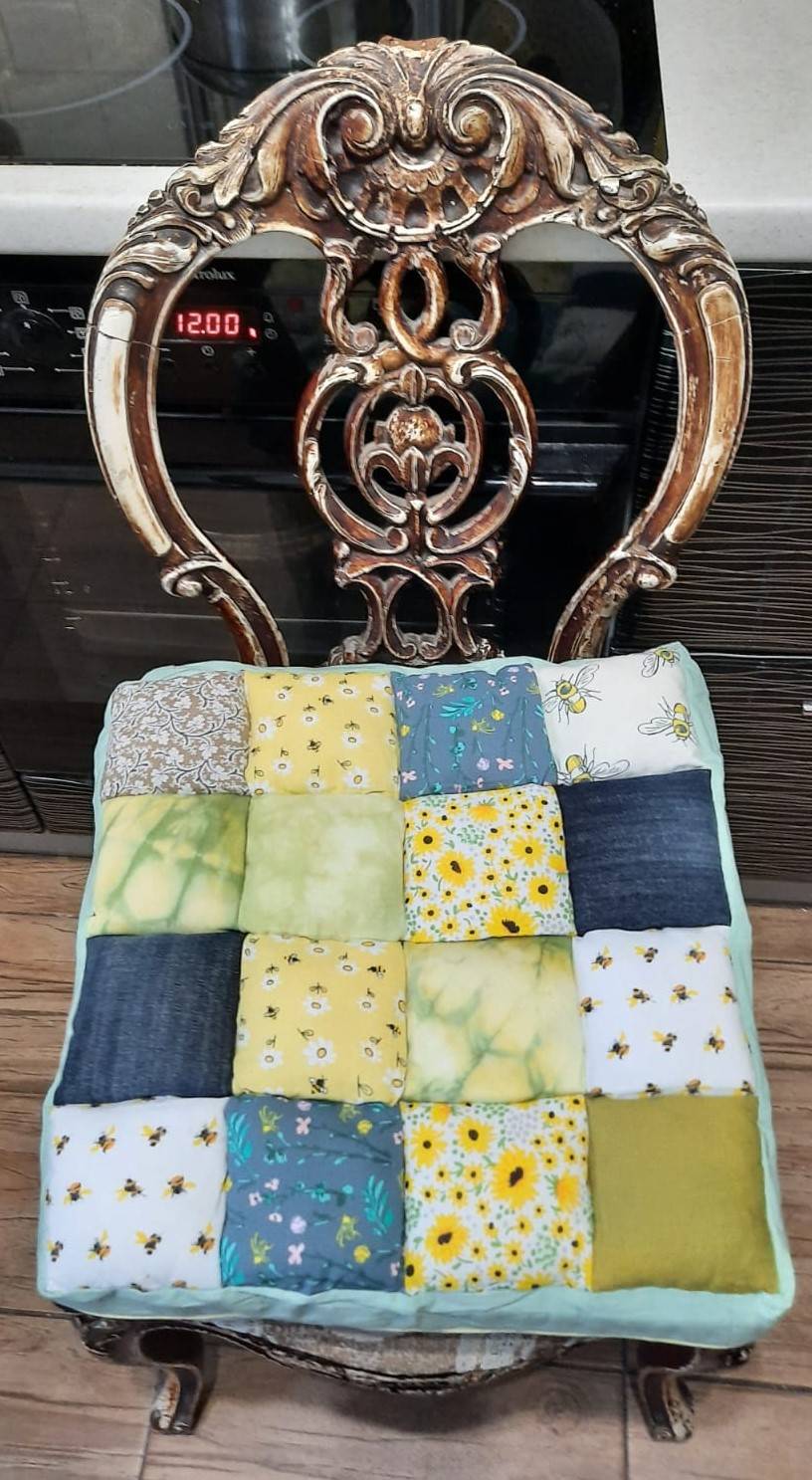 patchwork cushion on a baroque style kitchen chair